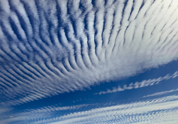 altostratus undulatus clouds. wavy stripy cloud formations. - cumuliform photos et images de collection