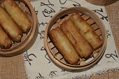 Vermicelli filling fried spring roll in bamboo steamer.