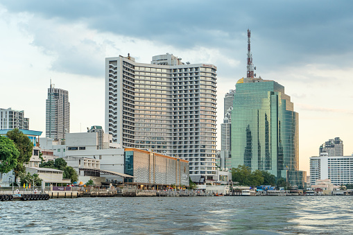 Skyscrapers on the banks of the Chao Phraya River, Bangkok, Thailand, view from the boat.