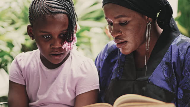 Mother teaches her daughter to read