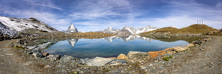 Near Gornergrat, Zermatt - A serene mountain lake mirrors the iconic Matterhorn and surrounding peaks, offering a moment of reflection amidst the grandeur of the Swiss Alps.