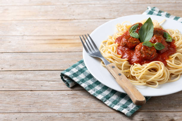 istock Spaghetti with meatballs on wooden table 2134896208