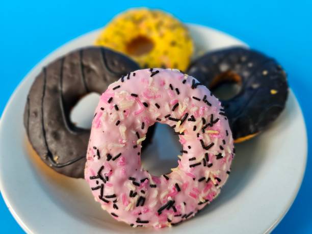 istock Variety of donuts piled high on a white plate 2134896212