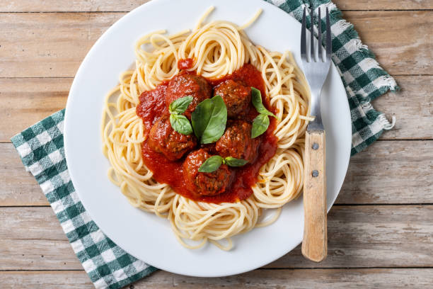 istock Spaghetti with meatballs on wooden table 2134896222