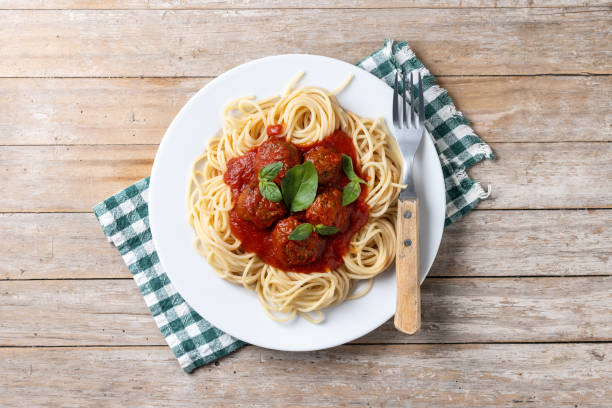 istock Spaghetti with meatballs on wooden table 2134896738