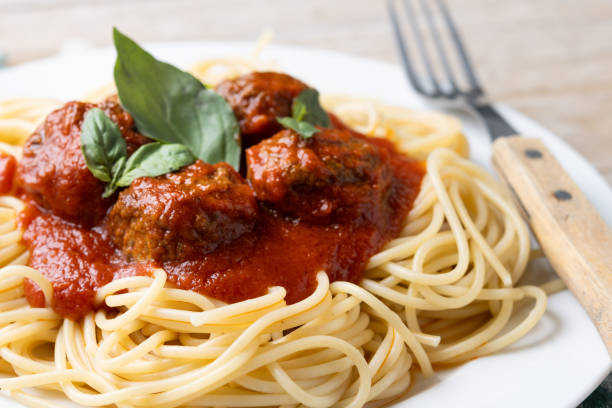 istock Spaghetti with meatballs on wooden table 2134897247