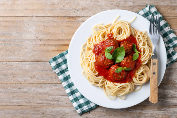 istock Spaghetti with meatballs on wooden table 2134897886