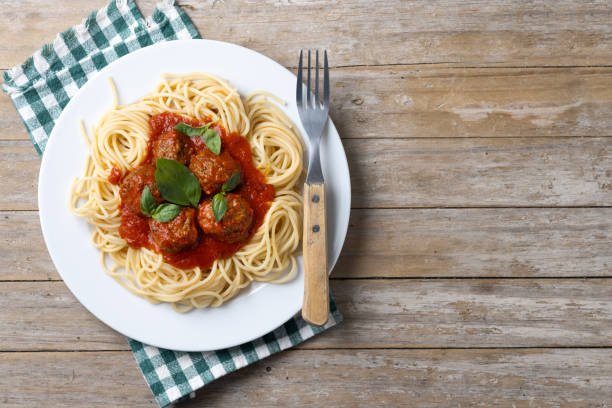 istock Spaghetti with meatballs on wooden table 2134898306