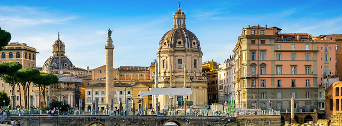 Rome, Italy, March 19 -- A suggestive cityscape of the Trajan's Forum in the Imperial Forums of Rome, in the historic heart of the Eternal City. In the background the baroque church of the Santissimo Nome di Maria al Foro and the Trajan Column, while in the foreground the remains of the majestic colonnade of the Basilica Ulpia, built in honor of the Emperor Trajan's family. The Roman Forum, one of the largest archaeological areas in the world, represented the political, legal, religious and economic center of the city of Rome, as well as the nerve center of the entire Roman civilization. In 1980 the historic center of Rome was declared a World Heritage Site by Unesco. Image in original 65x24 ratio and high definition quality.