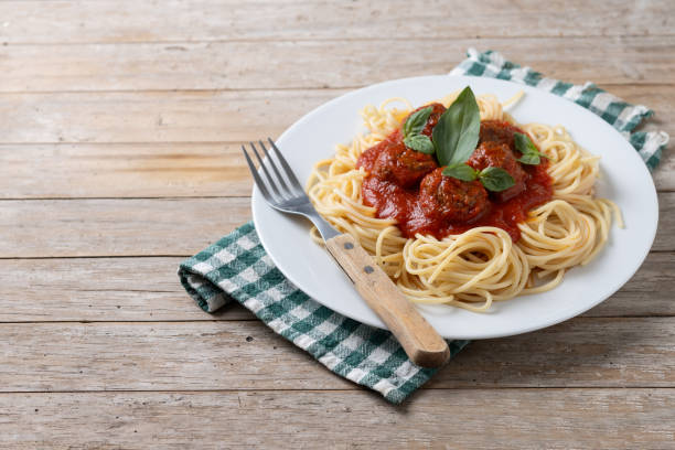 istock Spaghetti with meatballs on wooden table 2134898826