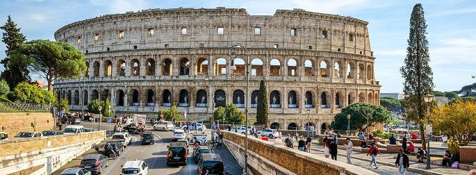 Rome, Italy, March 19 -- An impressive and detailed cityscape of the Colosseum or Coliseum and part of the Roman Forum, in the historic heart of Rome. The majestic Flavian Amphitheatre, known as the Colosseum due to a colossal statue that stood nearby, was built in the 1st century AD. at the behest of the emperors of the Flavian dynasty, and hosted, until the end of the ancient age, shows of great popular appeal, such as hunting with exotic animals, gladiator fights and even evocations of historical naval battles. The Roman Forum, one of the largest archaeological areas in the world, represented the political, legal, religious and economic center of the Ancient Rome, as well as the nerve center of the entire Roman civilization. In 1980 the historic center of Rome was declared a World Heritage Site by Unesco. Image in original 65x24 ratio and high definition quality.