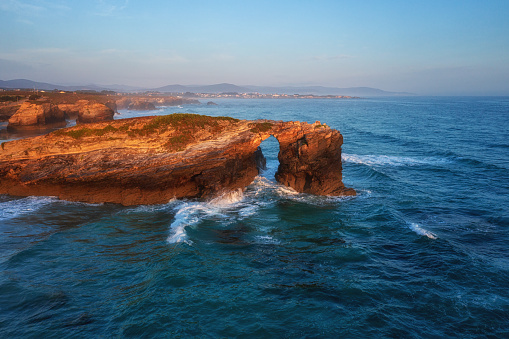 Aerial view of the Cathedrals beach (Playa de las Catedrales) or Praia de Augas Santas at sunrise, amazing landscape with rocks and Atlantic Ocean, Ribadeo, Galicia, Spain. Outdoor travel background