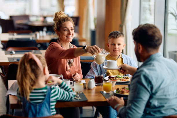 istock Happy family having a breakfast while staying in a hotel. 2134928444