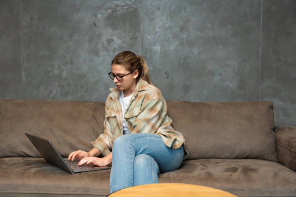 istock Side hustle money, second job concept. Young university student woman working freelance internet online job to pay student loan, saving money for rent, travel vacation Finance and economy video call 2134941221