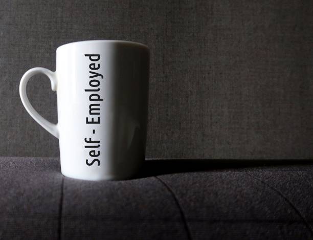 istock Coffee mug with inscription text Self-employed - means independent contractor or  sole proprietor who earn self-employment income - work for themselves in  variety of professions and occupations 2134951290