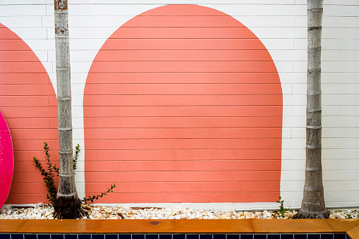 The poolside wall is painted in a stylish style that looks beautiful and natural.