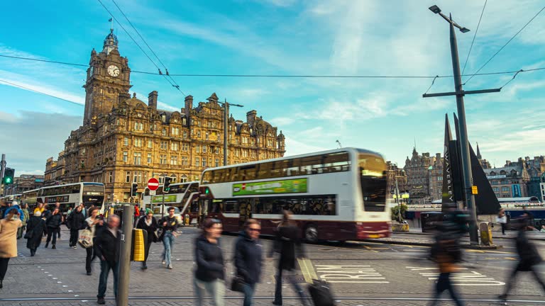 Time lapse of Crowded Commuter people and tourist walking and crossing road at Princes Street on rush hour near Edinburgh Waverley Railway Station in New Town, Edinburgh, Scotland, United Kingdom