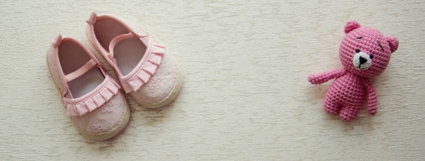 istock Children's shoes and teddy bear on a light background. Background with place for text 2135000036