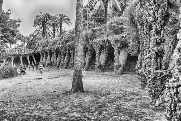 BARCELONA - AUGUST 9: Colonnaded pathway made with masonry arcades in Park Guell, Barcelona, Catalonia, Spain, on August 9, 2017. Designed by Antoni Gaudi, the park opened in 1926