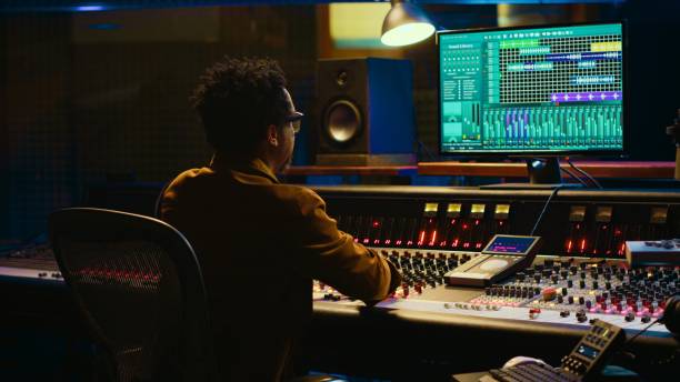 istock African american sound designer operates control desk mixer and audio software 2135028227