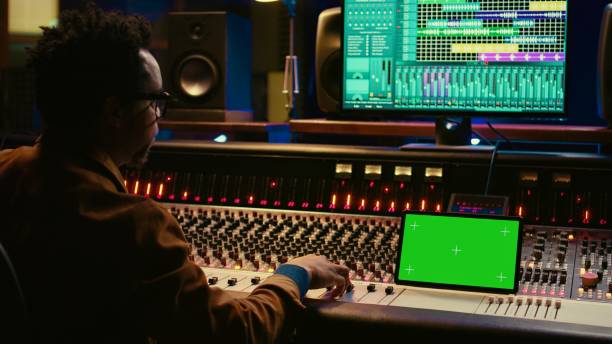 istock Sound engineer expert recording audio tracks next to tablet mockup 2135037216