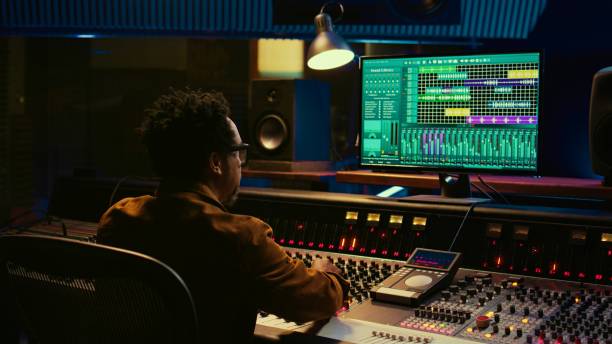 istock Audio expert counts down for artist singing in vocal booth, 2135042485