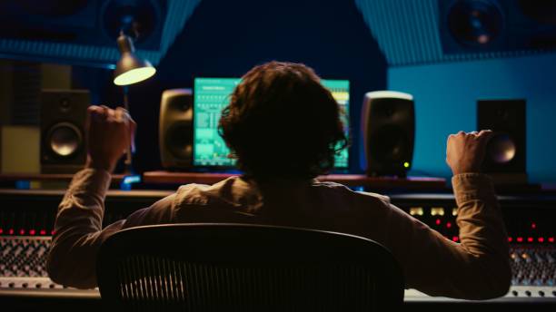 istock Skilled sound designer enjoying his own music creating at mixing console 2135044599