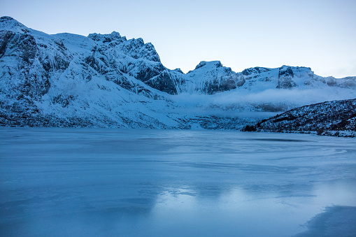 Icy lake in Nusfjord in winter, Lofoten, Norway