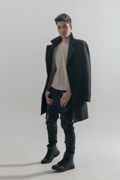 istock sexy casual man holding pockets while wearing overcoat 2135051680