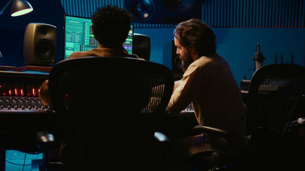 istock Audio expert and musician mixing and mastering tracks on control room console 2135053374