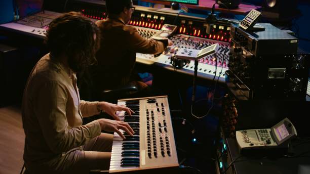 istock Skilled artist singer recording songs on electronic midi controller 2135057095