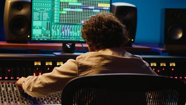 istock Cheerful energic audio engineer dancing on his own music creation 2135058166