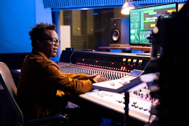 istock African american sound designer operating audio software to edit tracks 2135062421