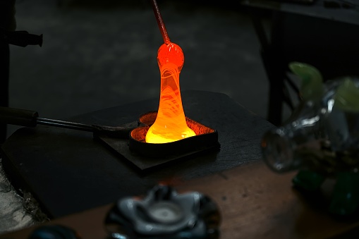 Art and old craft of glassblowing, hot melted glass