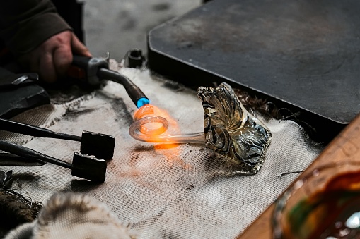 Art and old craft of glassblowing, hot melted glass