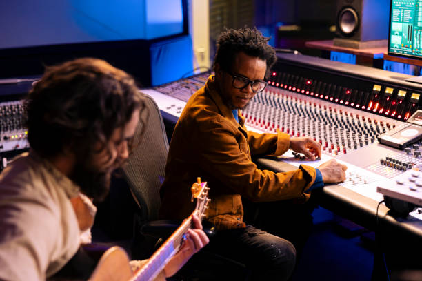 istock Artist playing a new record on his guitar in control room 2135066745