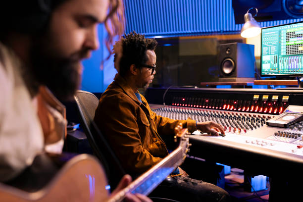 istock Talented singer composer recording guitar notes in professional music studio 2135068875