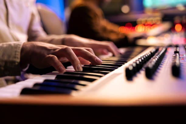 istock Singer songwriter creating new tracks on midi controller in studio 2135072606
