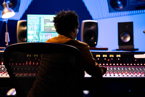 istock African american record engineer editing and mixing songs on studio console 2135073672