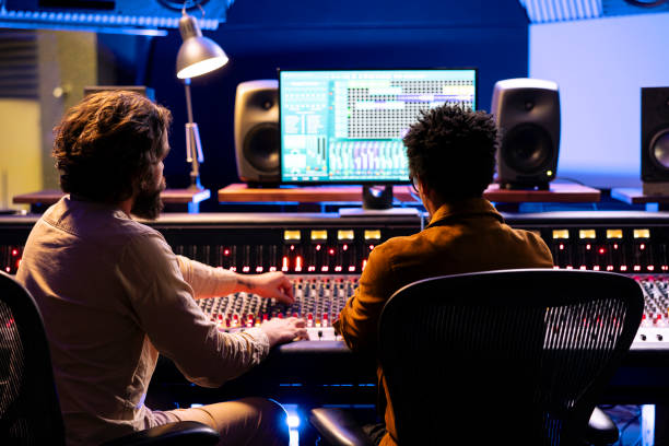 istock Artist and composer working together in recording music studio 2135074745