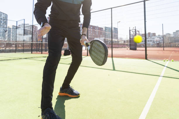 istock paddle tennis coach teaching on a residential paddle court, front view 2135076867