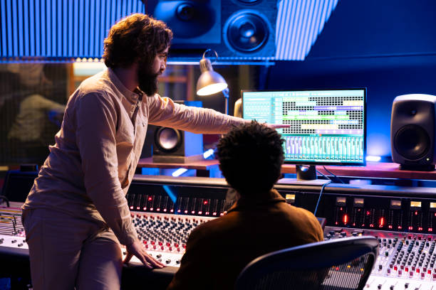 istock Skilled musician working with audio engineer to edit new recorded tracks 2135078437