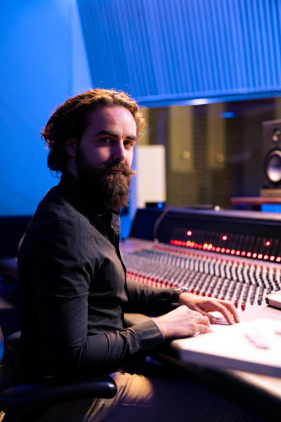 istock Portrait of sound engineer working with audio console and digital software 2135089750