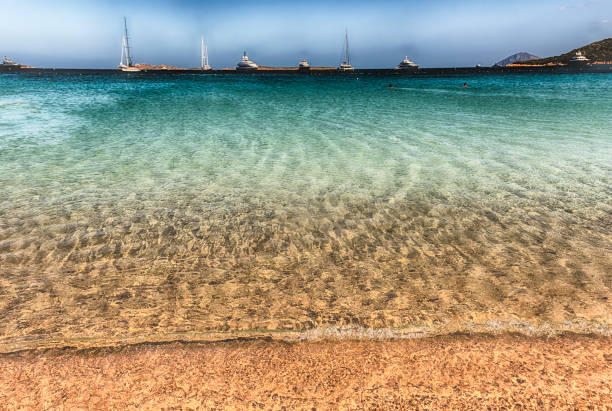 Luxury yachts standing in front of Liscia Ruja, one of the most beautiful beaches in Sardinia, Sardinia, Italy