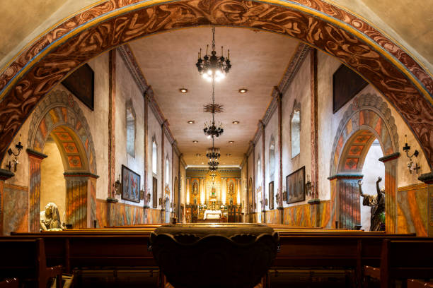 istock Interior of a church featuring multiple altars and wooden pew bench 2135109077