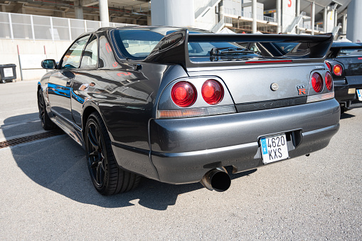 Montmelo, Spain – October 20, 2023: Rear view of a gray ninth-generation Nissan Skyline GT R33 at a Japanese sports car meet.