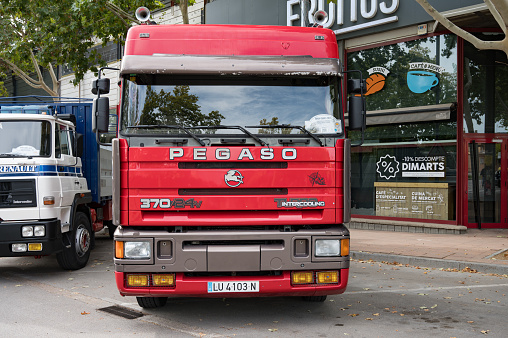 Caldes de Montbui, Spain – October 20, 2023: Front view of an old red tractor head truck, Pegaso Troner 370 24V 1237 40 TR Turbo Intercooler parked on the street