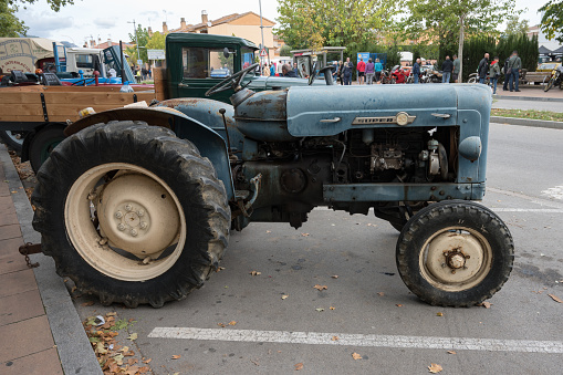Caldes de Montbui, Spain – October 20, 2023: Side view of an old blue Spanish tractor, the Ebro Super 55