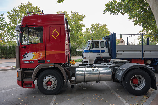 Caldes de Montbui, Spain – October 20, 2023: Side view of an old red tractor head truck, Pegaso Troner 370 24V 1237 40 TR Turbo Intercooler parked on the street