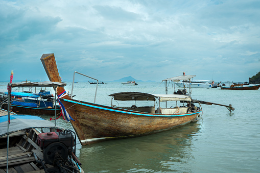 Monsoon dramatic sky, South-East Asian seascape with traditional fishing boats at Railay East, Krabi